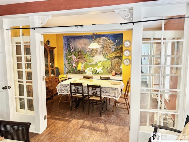 dining space with wood-type flooring