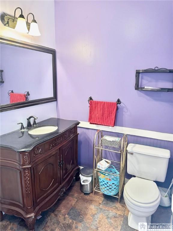 bathroom featuring vanity and toilet