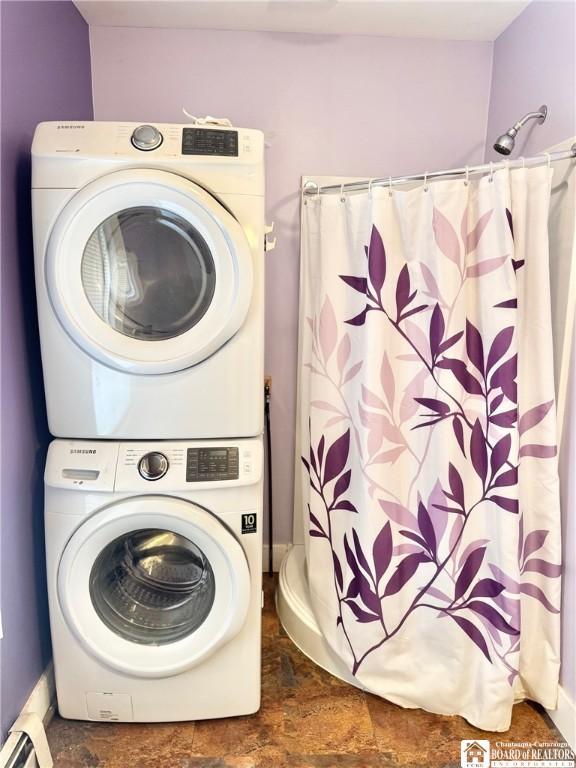 washroom featuring stacked washer and dryer