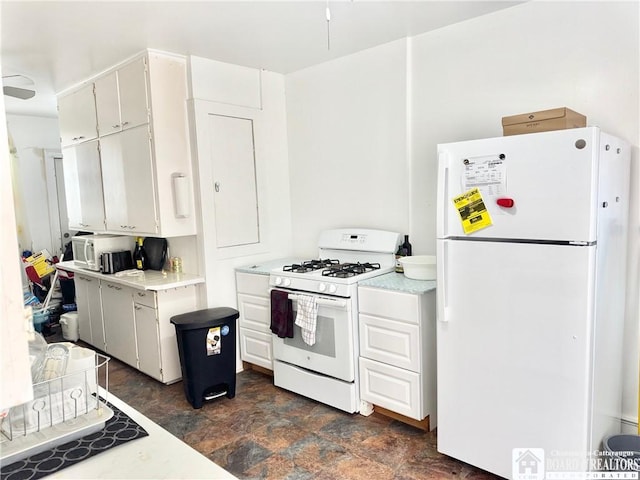 kitchen featuring white cabinetry and white appliances