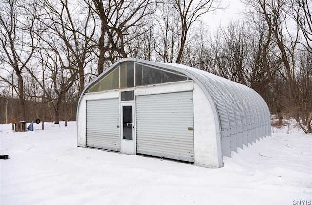 snow covered structure with an outdoor structure