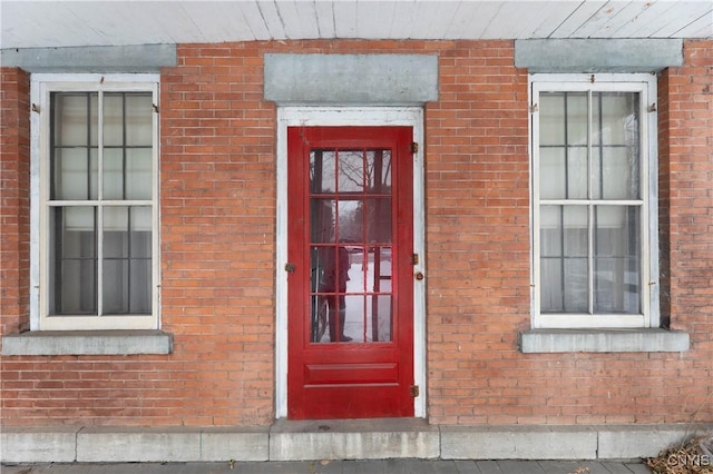 property entrance featuring brick siding