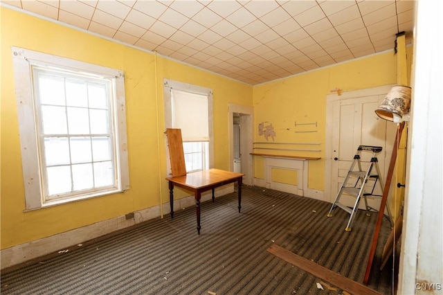 carpeted office featuring baseboards