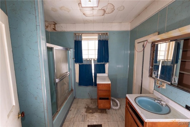 full bathroom with a stall shower, plenty of natural light, and vanity