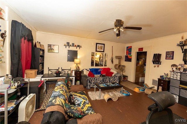 living room with visible vents, ornamental molding, wood finished floors, and a ceiling fan