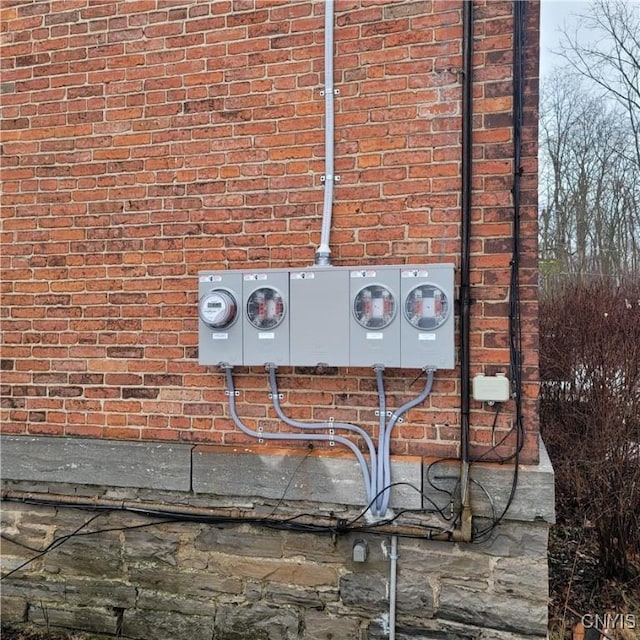 details with electric meter and brick siding