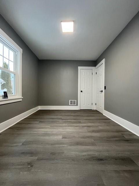 unfurnished room featuring dark hardwood / wood-style floors