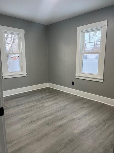 empty room with hardwood / wood-style flooring