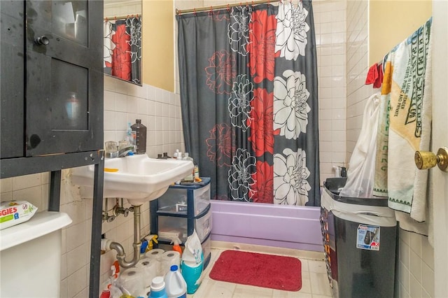 bathroom featuring toilet, tile patterned flooring, tile walls, and shower / bath combo