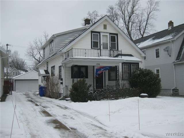 view of front of home with a garage, a balcony, an outdoor structure, and a porch