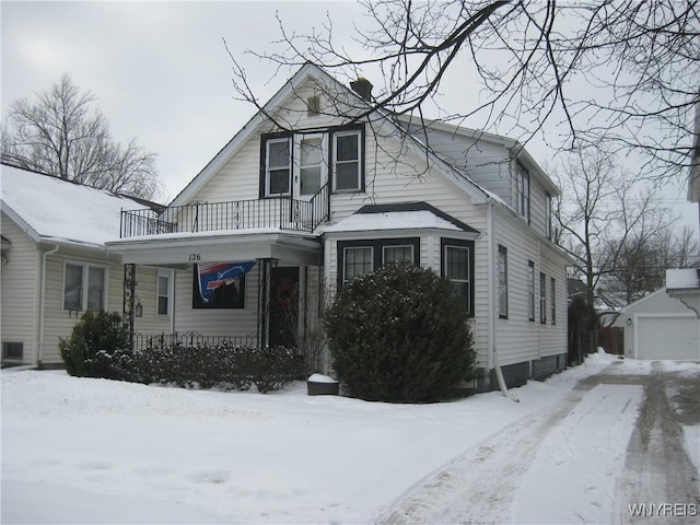 view of front of property with an outbuilding, a balcony, and a garage