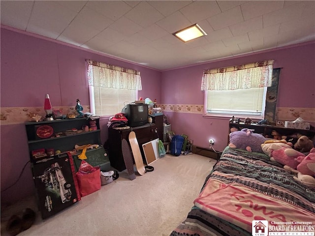 bedroom featuring a baseboard heating unit and carpet flooring