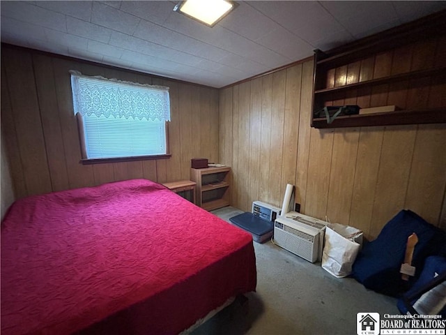 bedroom featuring carpet floors and wood walls