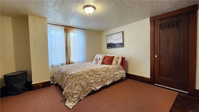 carpeted bedroom featuring a textured ceiling