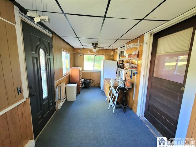 interior space with a drop ceiling and ceiling fan