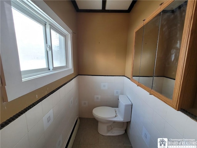 bathroom with tile walls, a baseboard heating unit, tile patterned flooring, and toilet