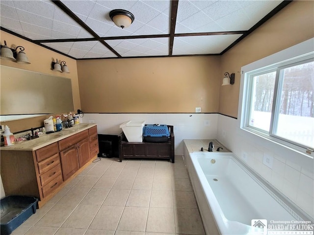 bathroom featuring vanity, tile patterned flooring, a bathtub, and a drop ceiling