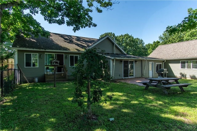 rear view of property featuring a yard