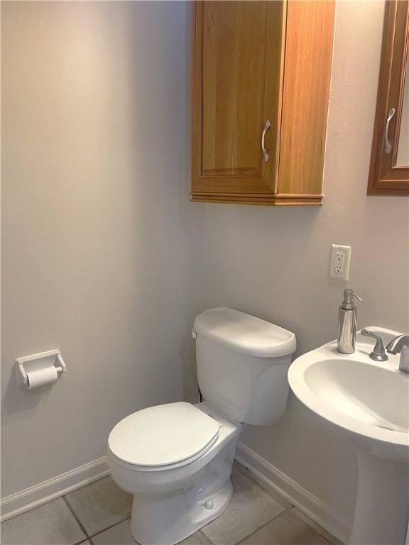 bathroom featuring tile patterned floors, toilet, and sink