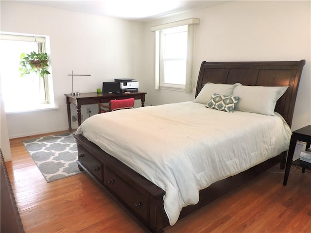 bedroom with dark hardwood / wood-style flooring