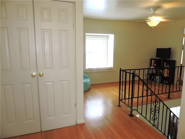 corridor with hardwood / wood-style floors