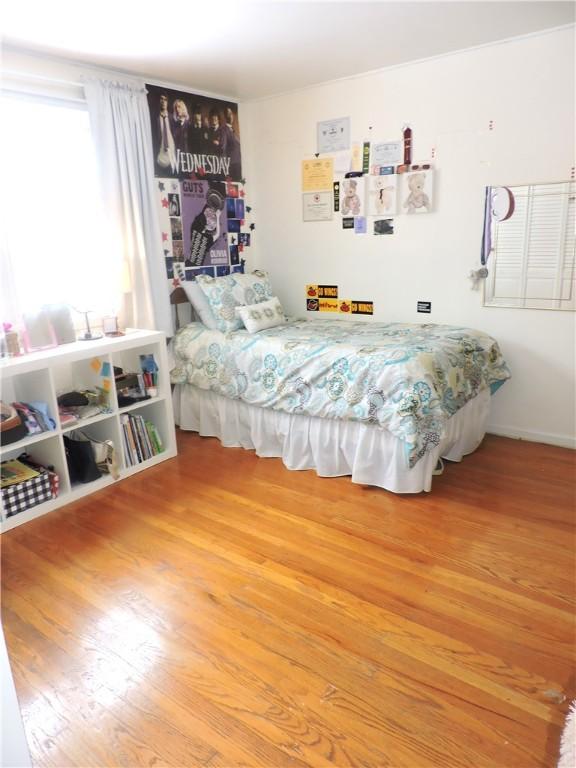 bedroom with hardwood / wood-style flooring