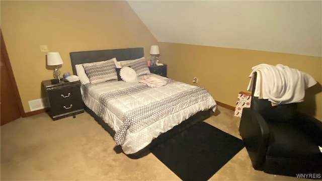 bedroom with lofted ceiling and light colored carpet