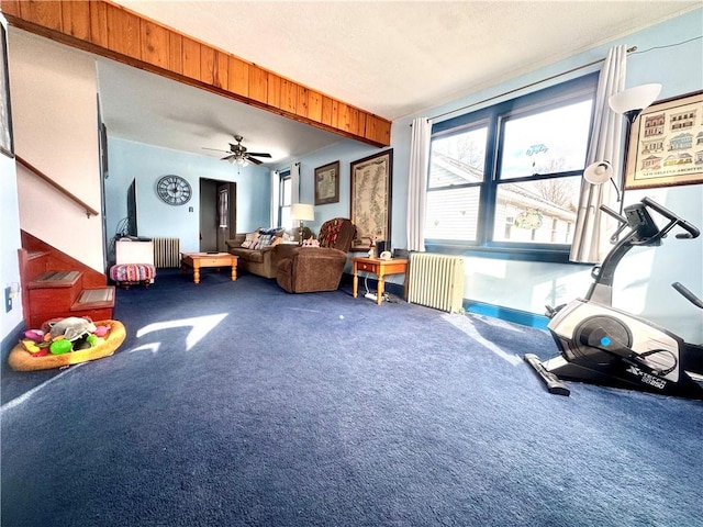 interior space featuring carpet flooring, radiator heating unit, and ceiling fan