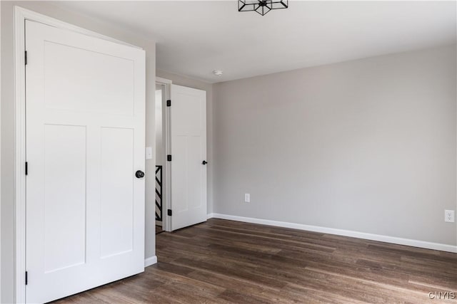 spare room with dark hardwood / wood-style flooring