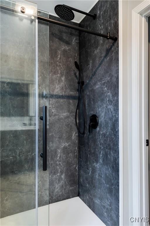 bathroom with a shower with door