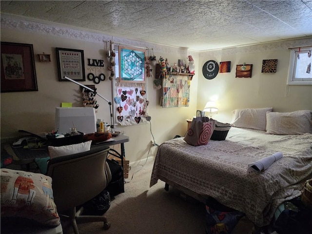 bedroom featuring carpet floors and a textured ceiling