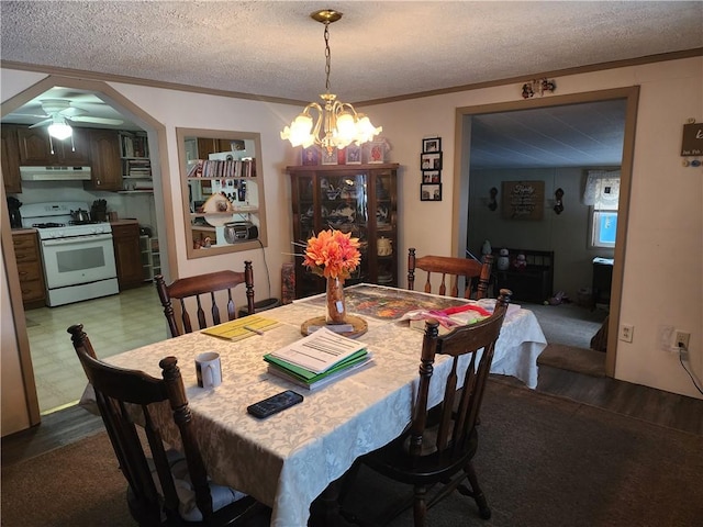 dining room featuring a notable chandelier, crown molding, and a textured ceiling