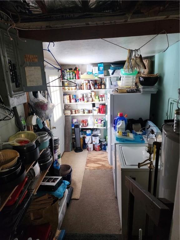 laundry room with washing machine and clothes dryer, carpet flooring, and electric panel