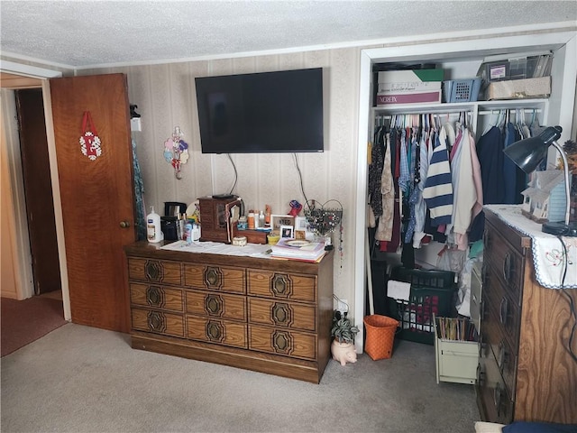 carpeted bedroom featuring a closet and a textured ceiling