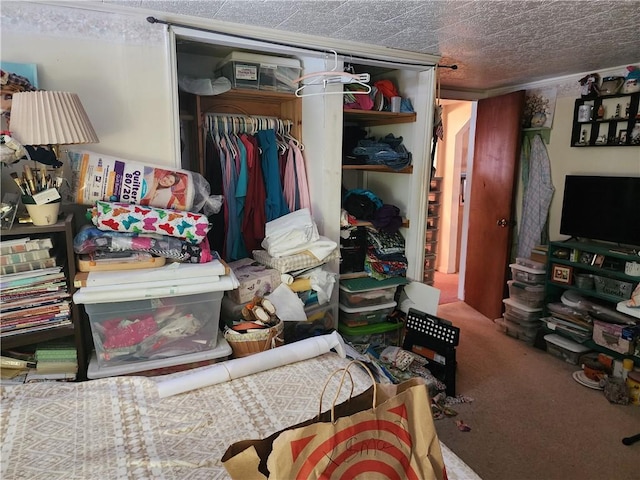 carpeted bedroom featuring a closet and a textured ceiling