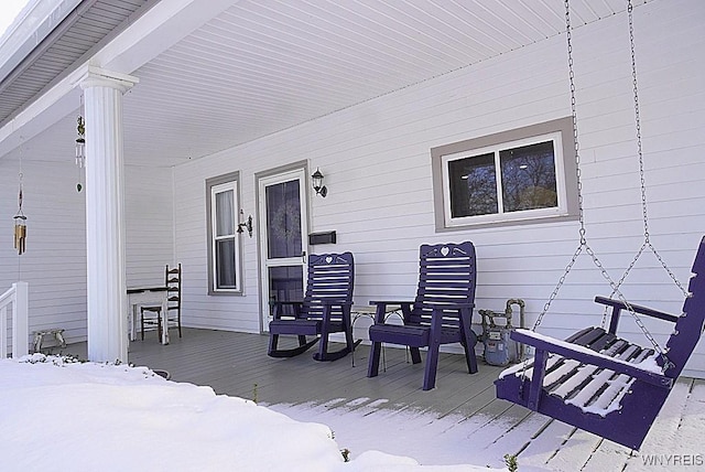 snow covered deck with covered porch