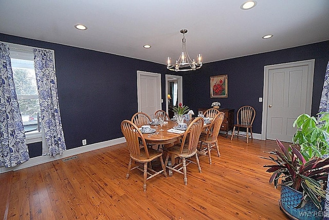 dining area featuring a chandelier and light wood-type flooring