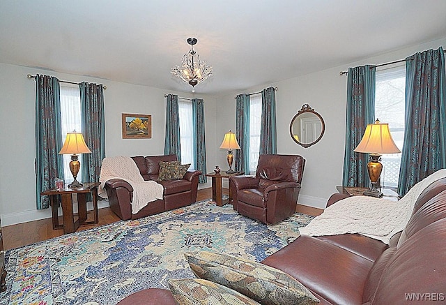 living room with wood-type flooring and a notable chandelier