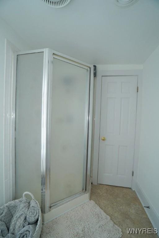 bathroom with a shower with shower door