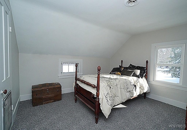 bedroom featuring vaulted ceiling and dark colored carpet