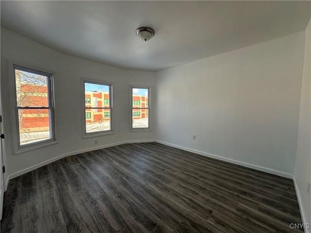 empty room featuring dark wood-type flooring