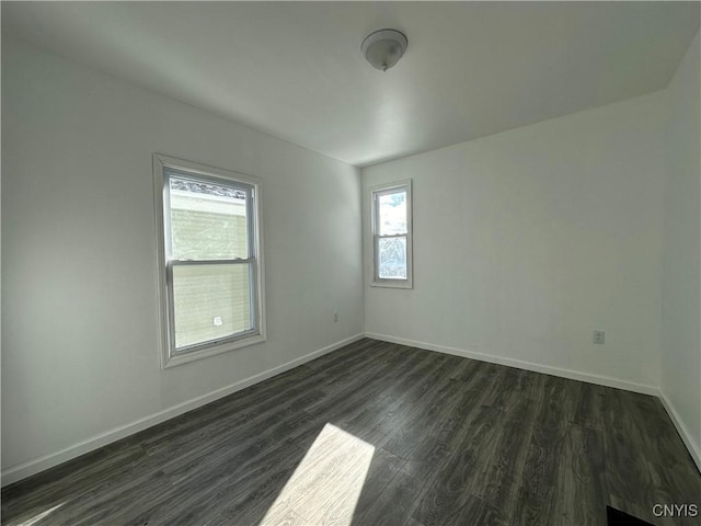 spare room with dark hardwood / wood-style flooring