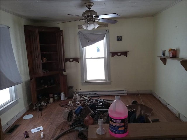 interior space featuring hardwood / wood-style floors, crown molding, and ceiling fan