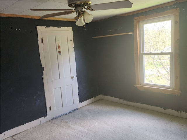 spare room featuring carpet and a ceiling fan