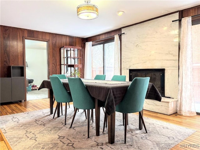 dining space featuring hardwood / wood-style flooring and a premium fireplace