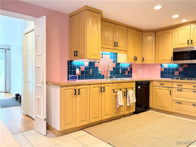 kitchen featuring sink, decorative backsplash, stainless steel appliances, and light tile patterned floors