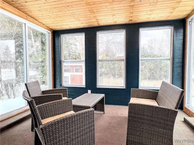 sunroom / solarium featuring wooden ceiling and a healthy amount of sunlight