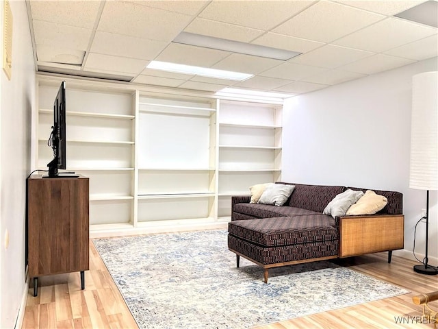 sitting room featuring hardwood / wood-style flooring and a paneled ceiling