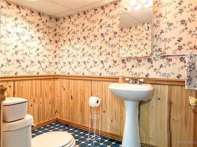 bathroom with a drop ceiling and toilet