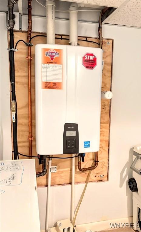 utility room featuring tankless water heater